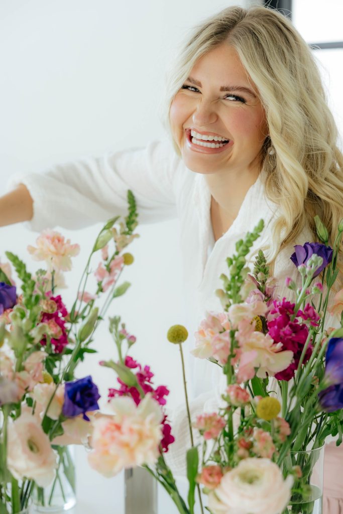 Kloe Brown, florist and owner of Flora by Klo, with a garden-style arrangement
