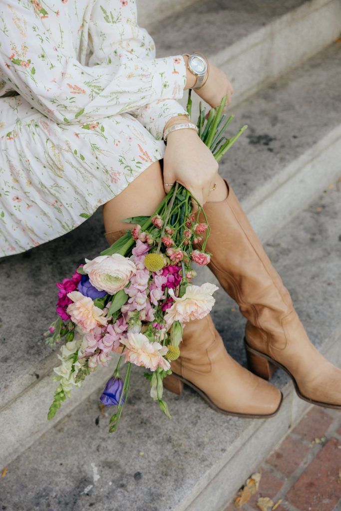 Pastel wildflower bouquet held on stone steps