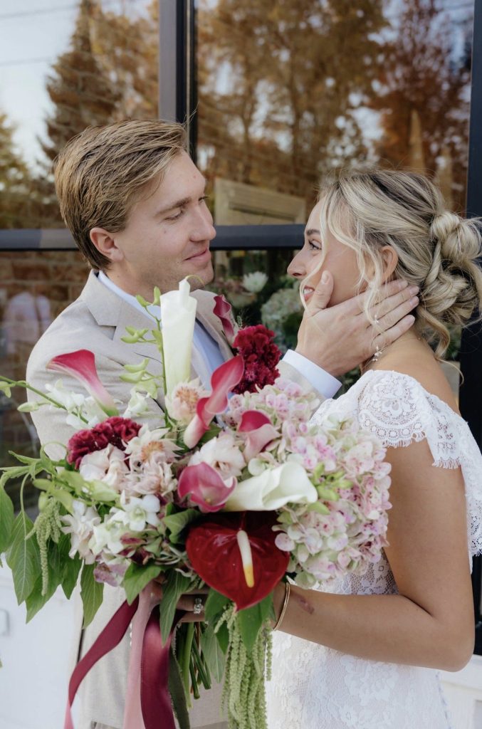 Bride and groom with a burgundy, blush and calla lily bridal bouquet