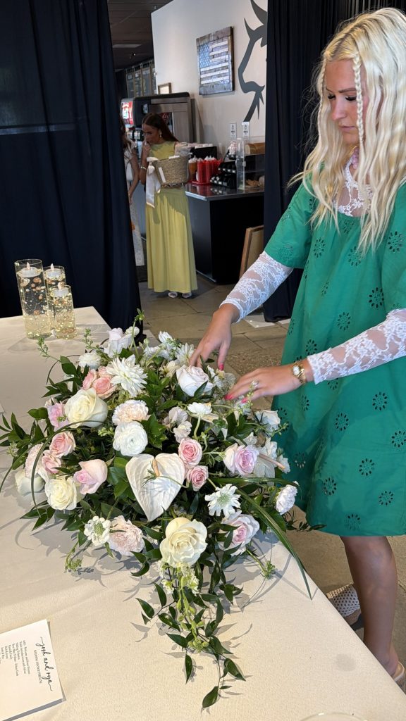 Florist designing a white and green centerpiece