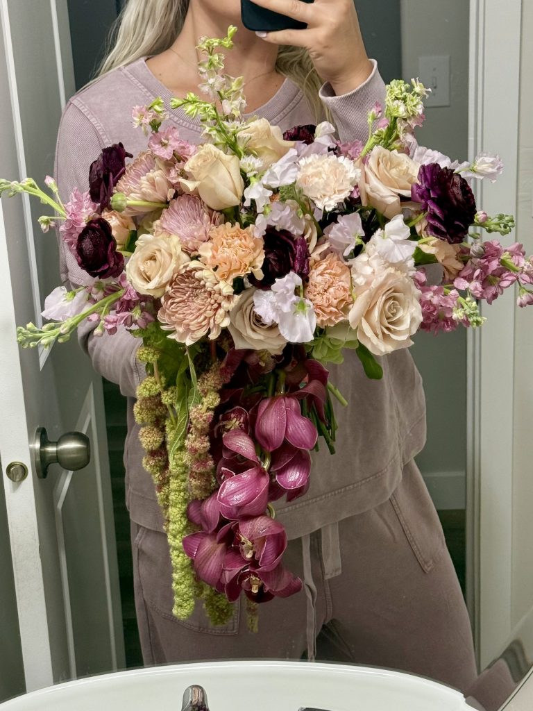 Garden bouquet in mauve, peach and burgundy with hanging orchids