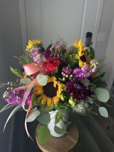 Colorful vase arrangement with sunflowers, dahlias and roses