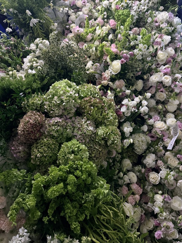 Lush floral wall of hydrangea, roses and greenery