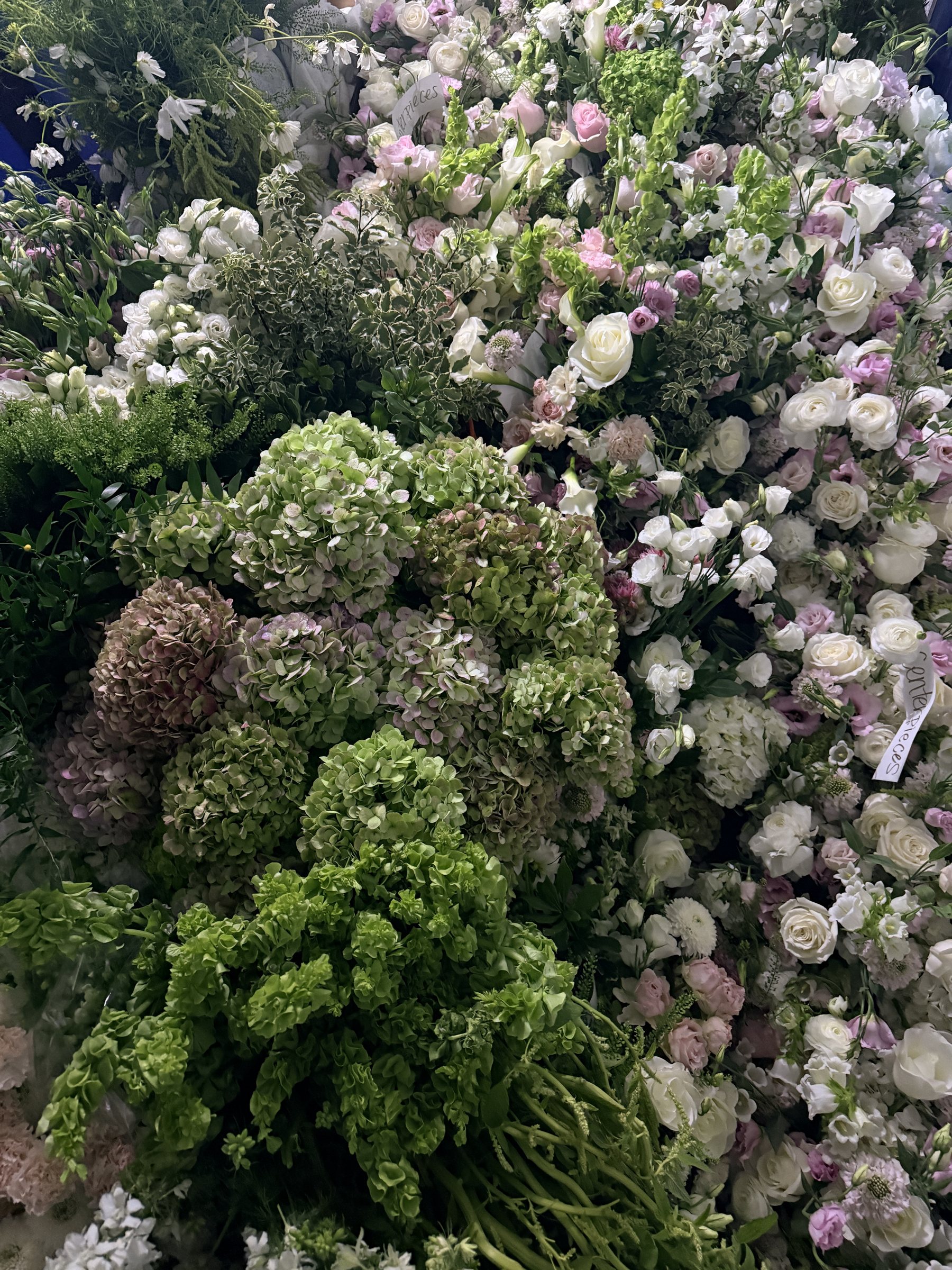 Lush floral wall of hydrangea, roses and greenery